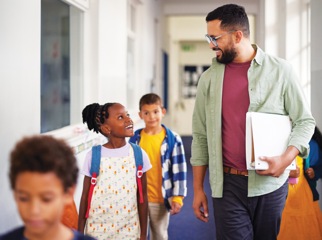 Students and teacher in school hallway