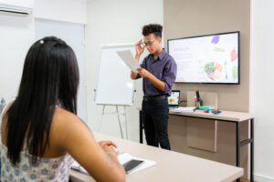 Licensed from Getty: Teacher at front of room